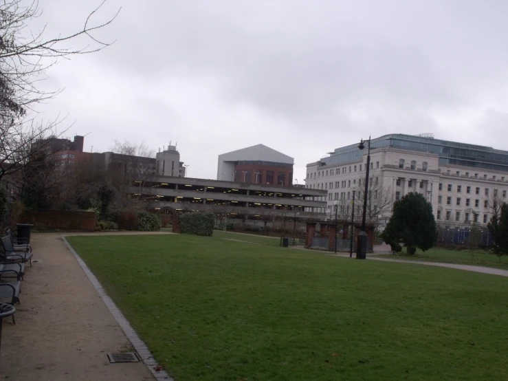 a grassy field in front of an old building