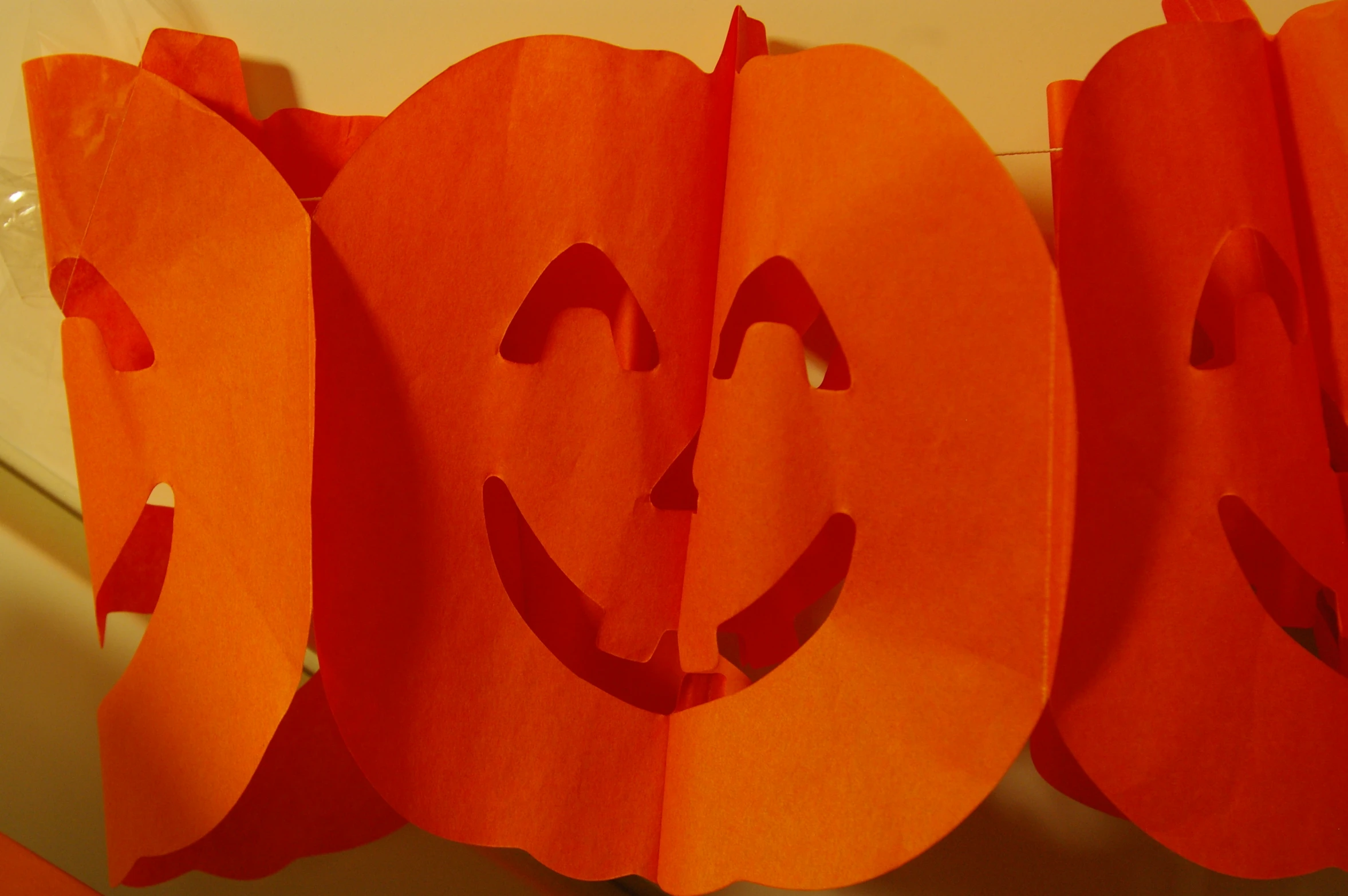 a group of orange bags with the faces of a pumpkin