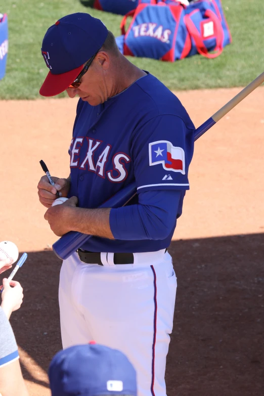 a baseball player standing in front of his catcher on the field