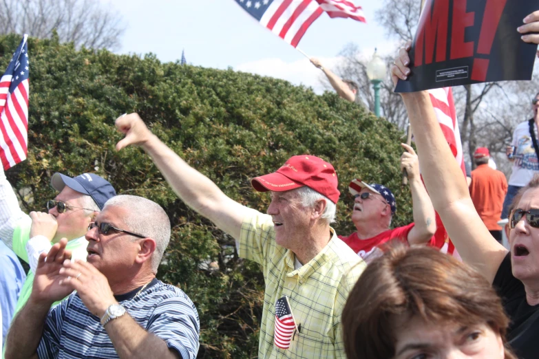 some people are standing in a field with flags