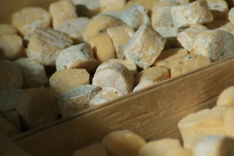 a wooden box full of peeled bananas