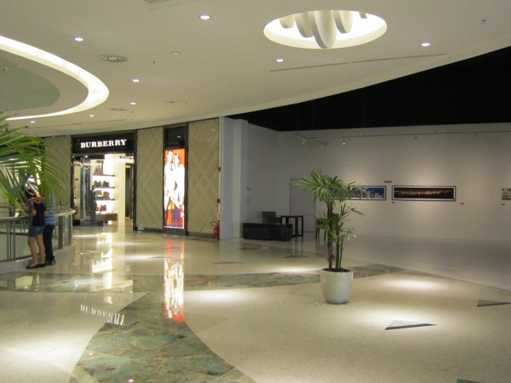 people are standing inside of an exhibit center