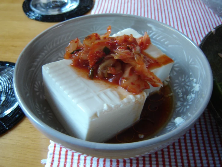 two square pieces of cheese in a bowl