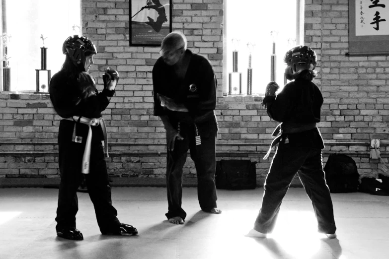 this is two young people practicing karate in an indoor facility