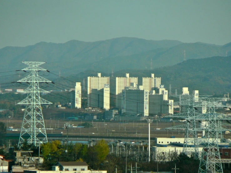 a city and its electric towers are seen from above