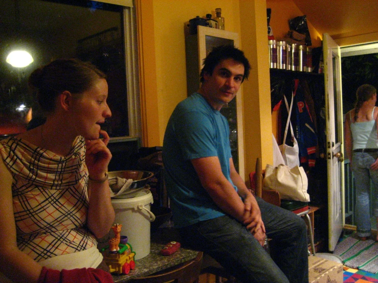 three people in front of a house with an open doorway