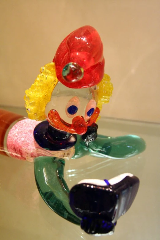 a glass figurine in the shape of a clown