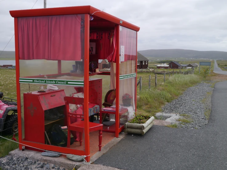 a group of red items near a small building