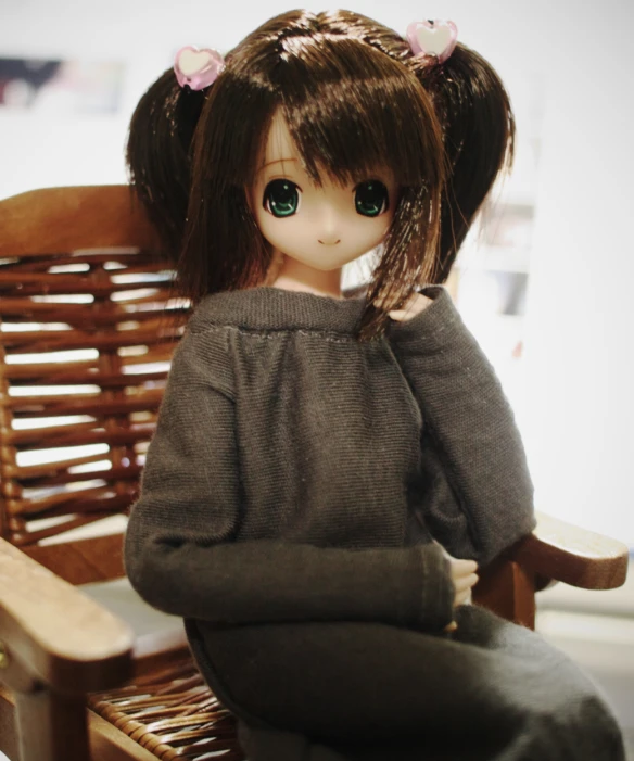 a doll sits in a wooden rocking chair