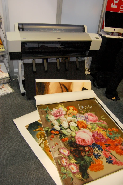 several different types of prints on display with a man in the background