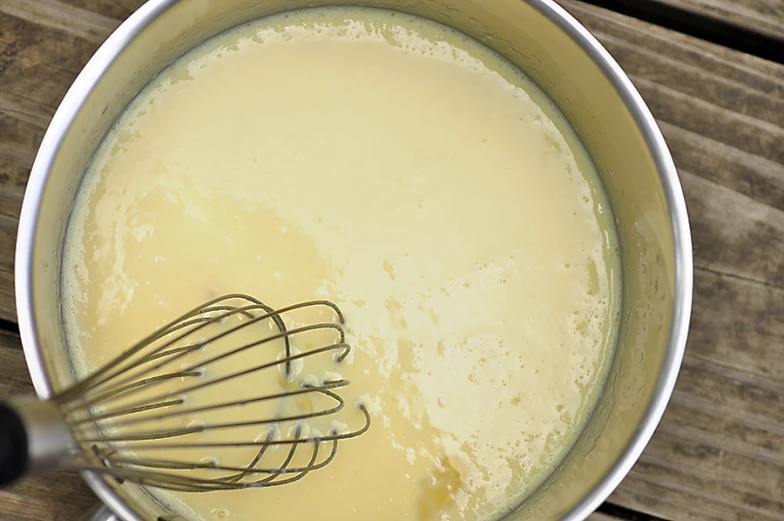 a whisk is being added to food batter