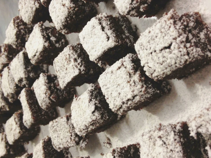 a picture of some brownies with powdered sugar