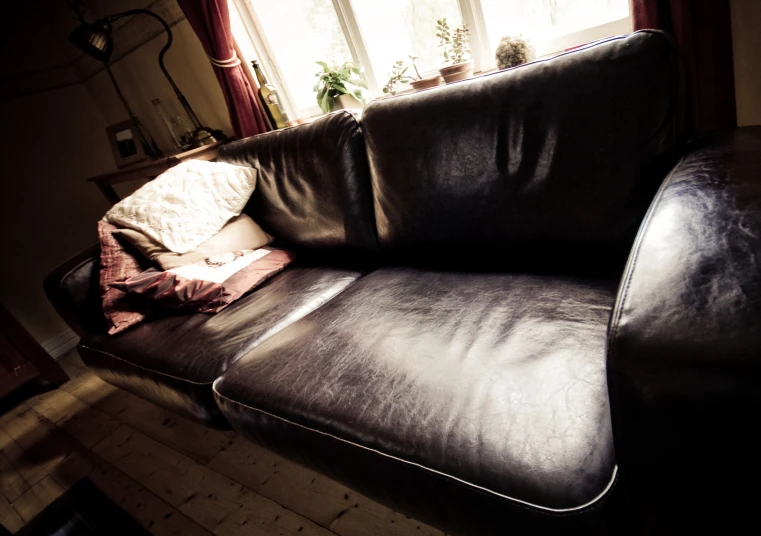 a brown leather couch in a room