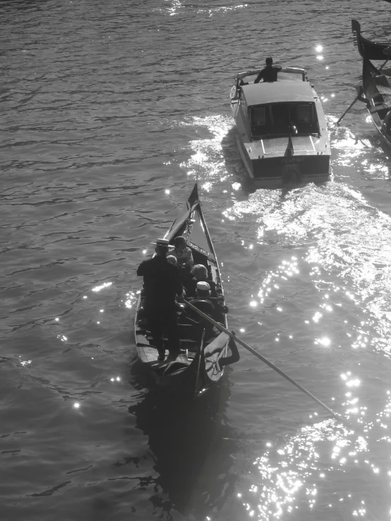 three boats in the water moving one on a wire