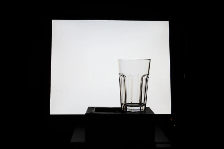 there are two empty drinking glasses, one in a black and white image