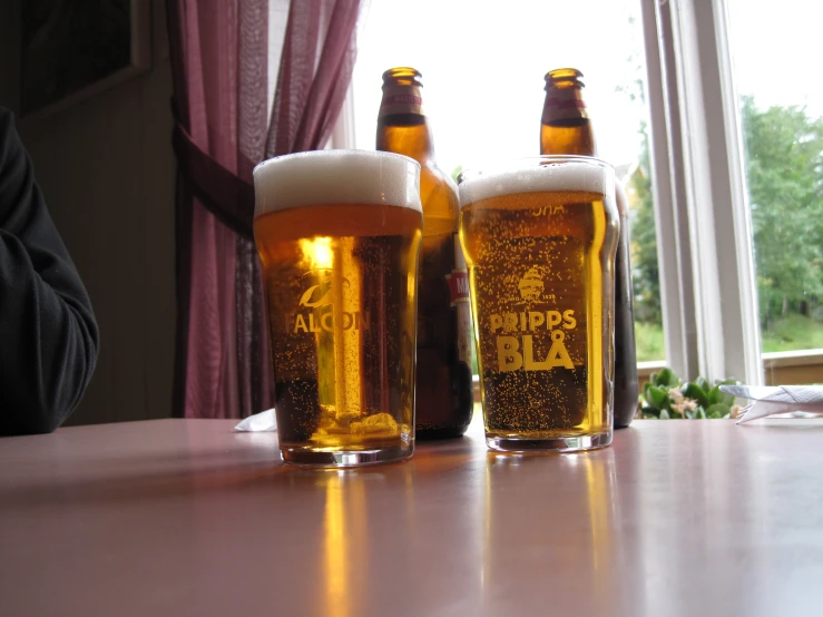 three beers are placed next to each other on the table