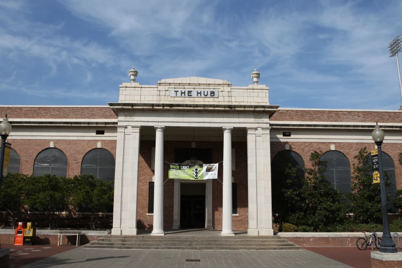 a building with pillars, columns and sign