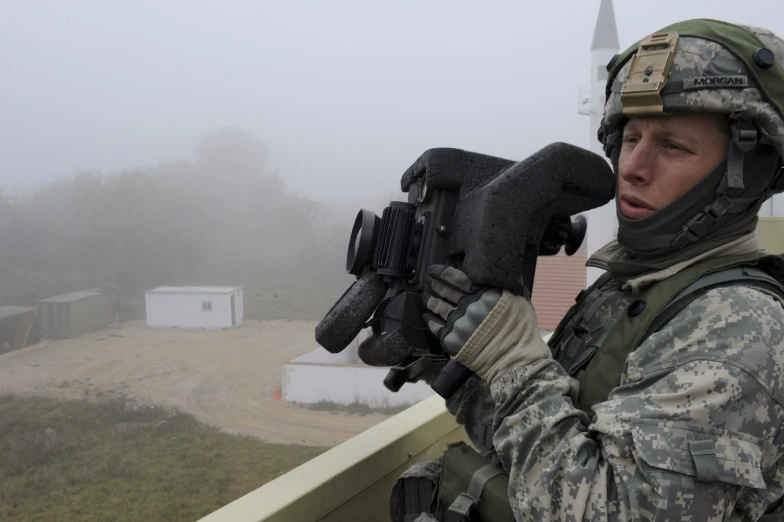 a person wearing gloves and holding a gun