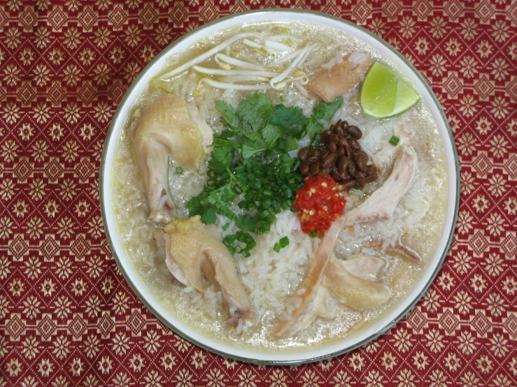 a white bowl with soup with broccoli and chicken