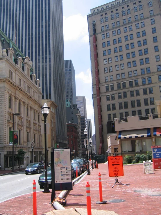 city intersection in the middle of downtown, with several tall buildings on either side