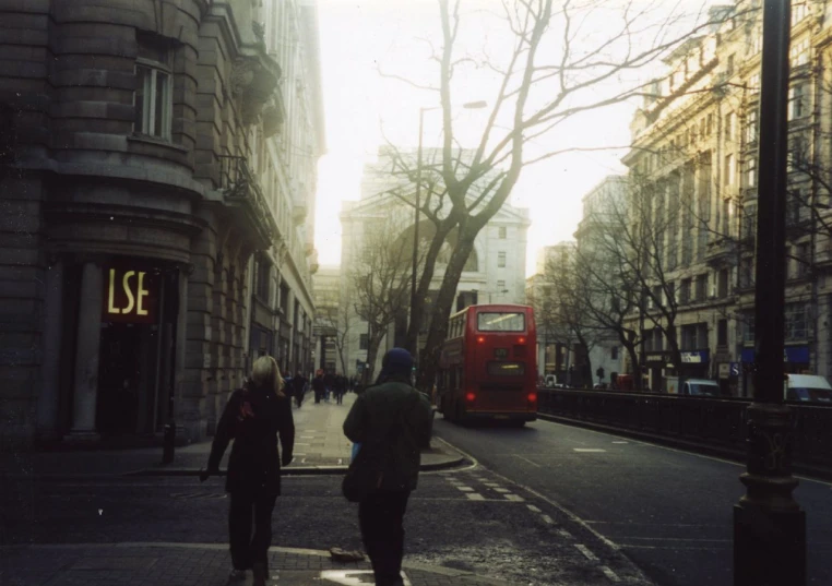 people walking down the side walk of a street