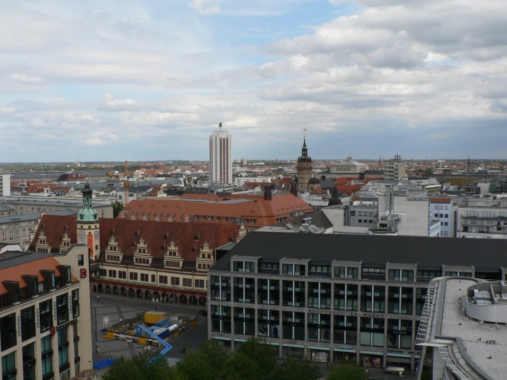 a large clock tower towering over a city with lots of buildings