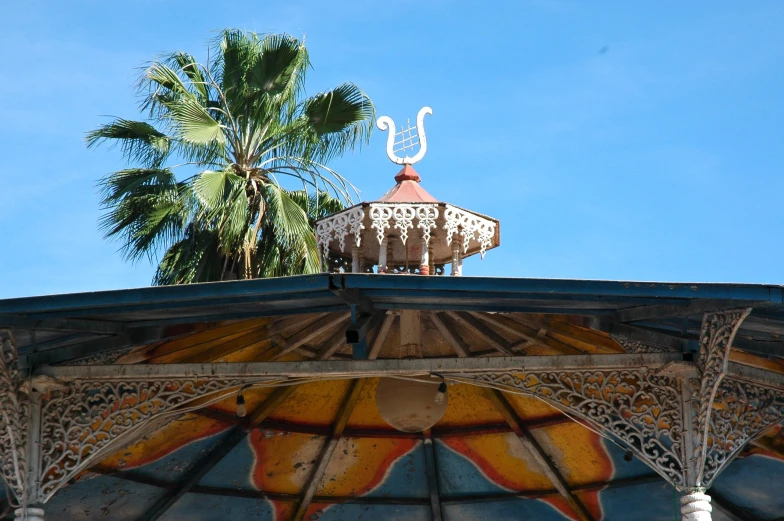 a building on a clear day and a palm tree in the background