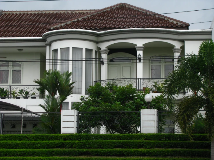 a white house with a tall red roof