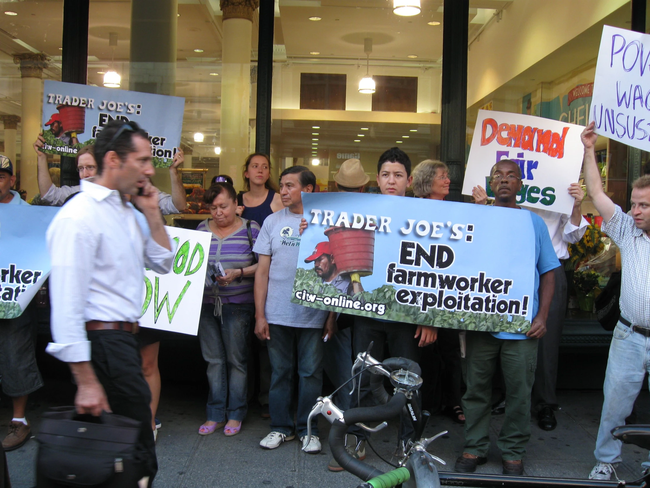 a protest rally with a group of protesters holding up signs