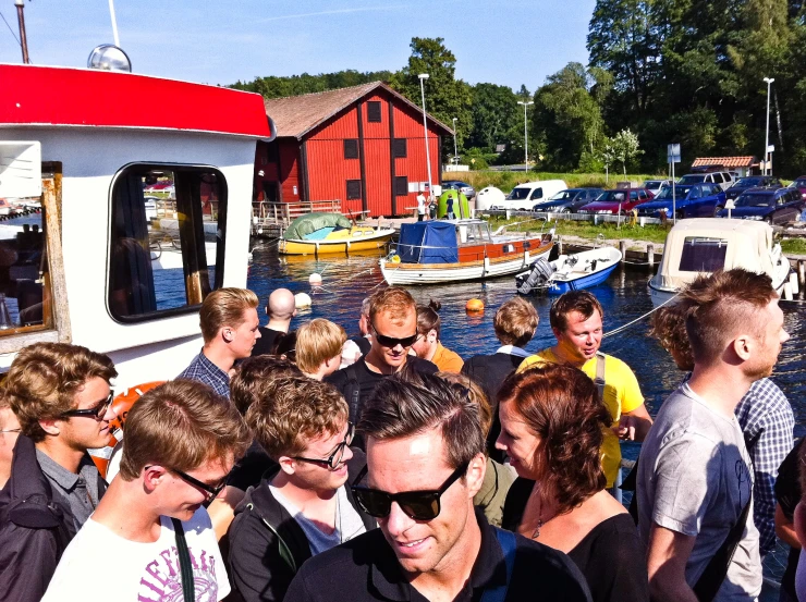 a group of people standing in front of a small boat