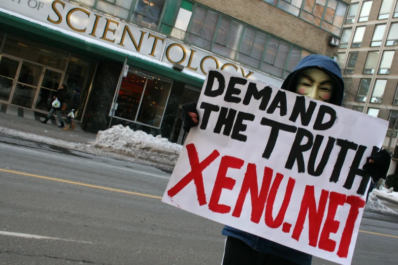 a protester is holding up a sign while standing outside