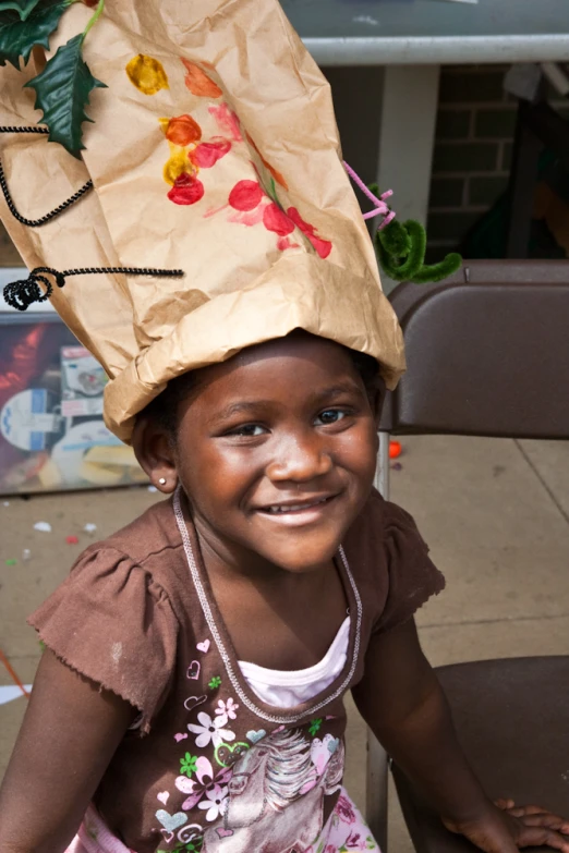 a little girl that has a bag on her head