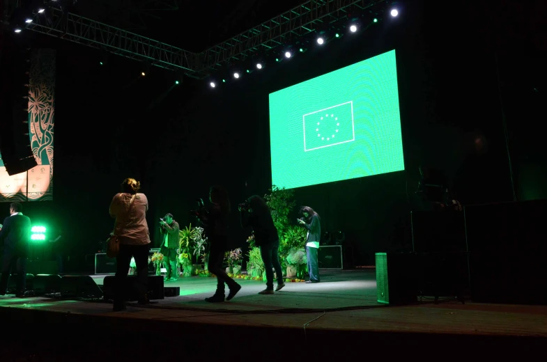 people on stage at night, performing