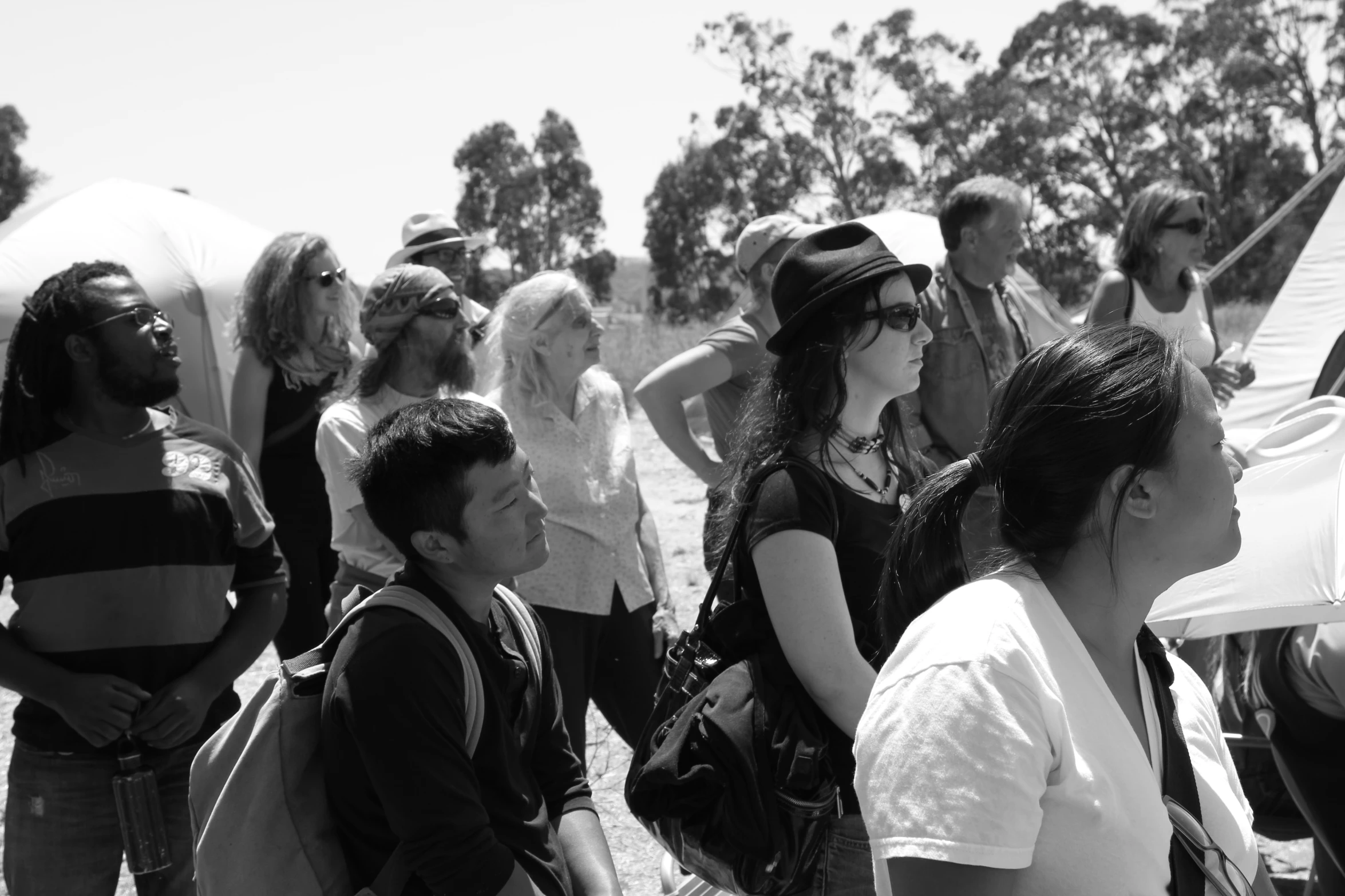 some people are standing in a line, one is wearing head scarves