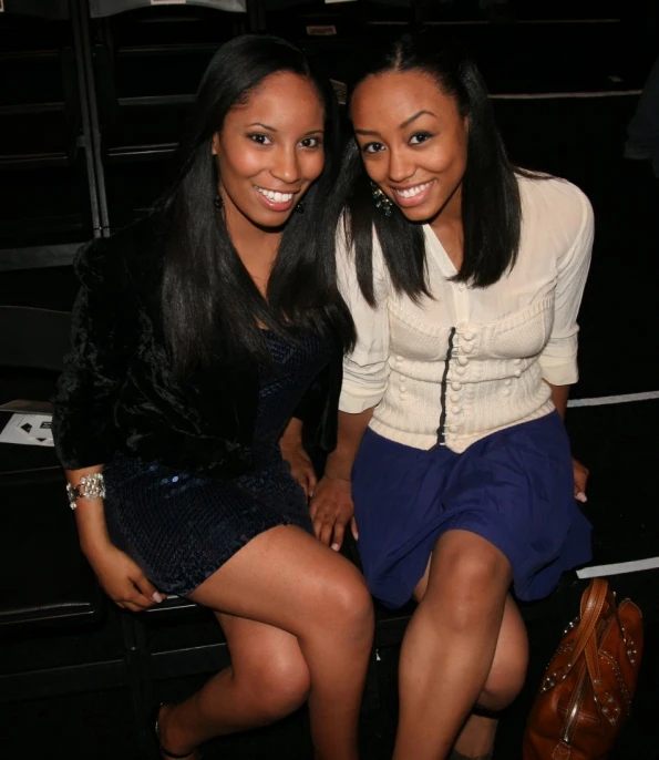 two beautiful young ladies sitting next to each other