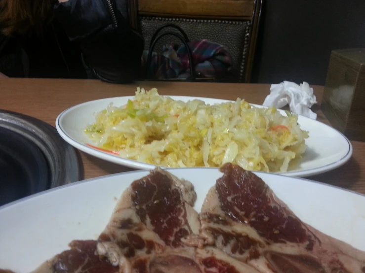 plates of food with meat and coleslaw on them