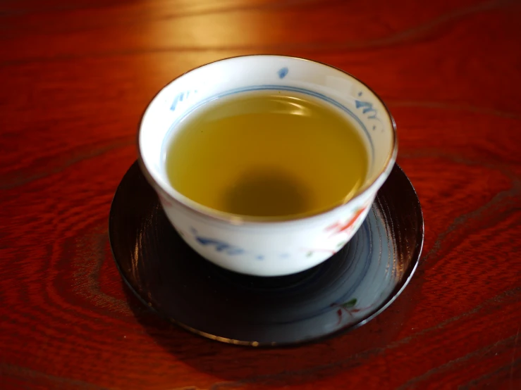 an empty china cup filled with green tea