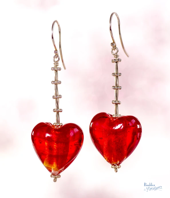 two red glass hearts with silver wire dangles hanging from them