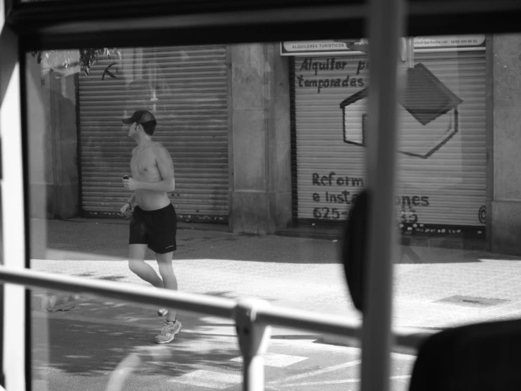 man running by building and book on window