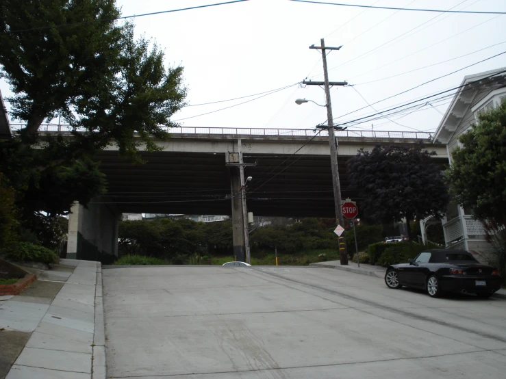 a street with a railroad crossing over it