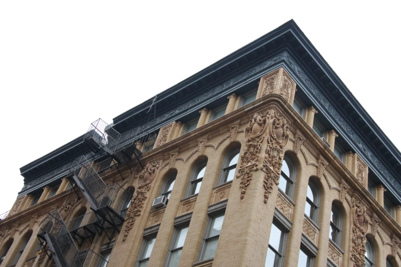 a tall brick building has ornate windows