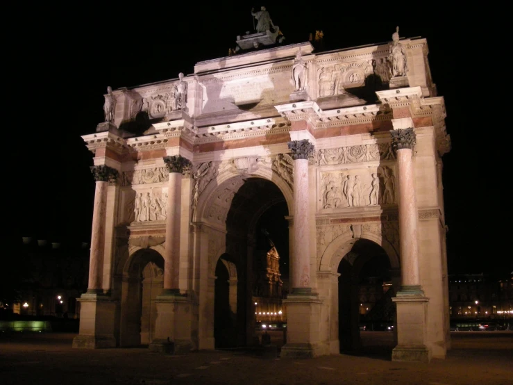 the intricate archway has a statue on top