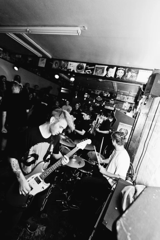 black and white pograph of a band playing in a music studio