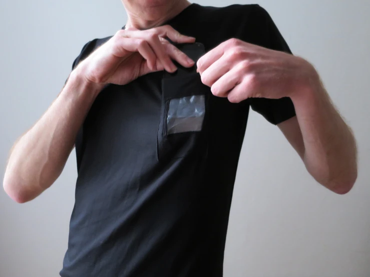 man in black shirt holding a pair of finger grips