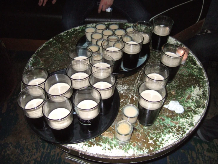 beer glasses arranged around a large tray that is filled with ss