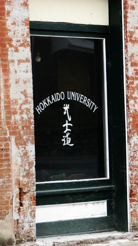 an oriental writing sign is on the window of a building