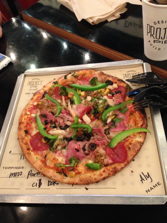 a pizza sits on a tray on a counter top