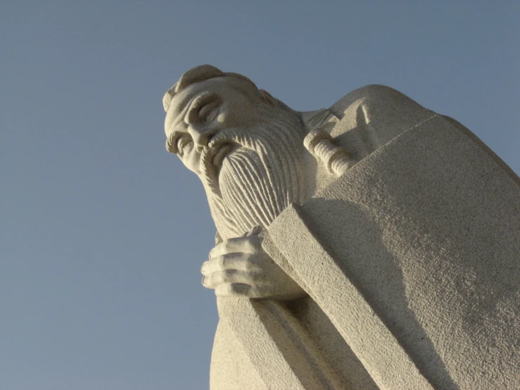 the stone statue is wearing a hat