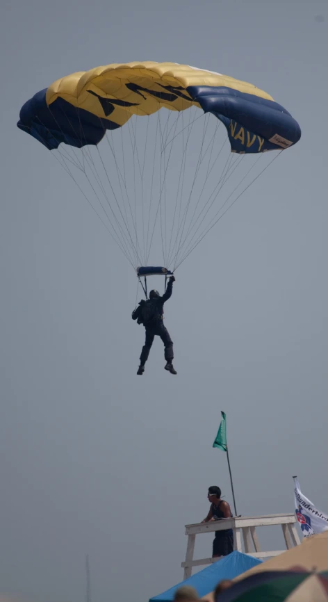 a navy is parachuting in the sky with his parachute