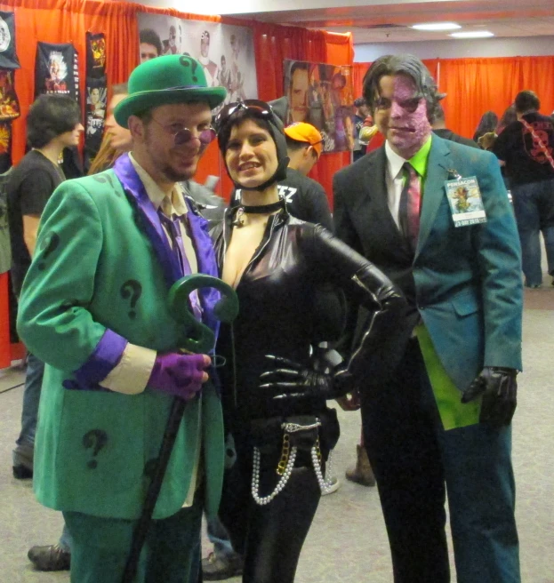 three people in costumes posing for the camera